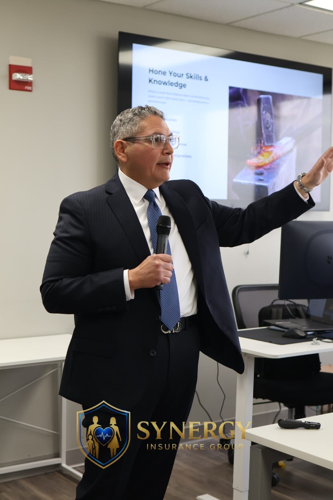 A Synergy advisor presenting at a team training session in the office.